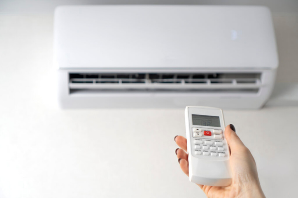 Technician adjusting a ductless air conditioner in Santa Clarita